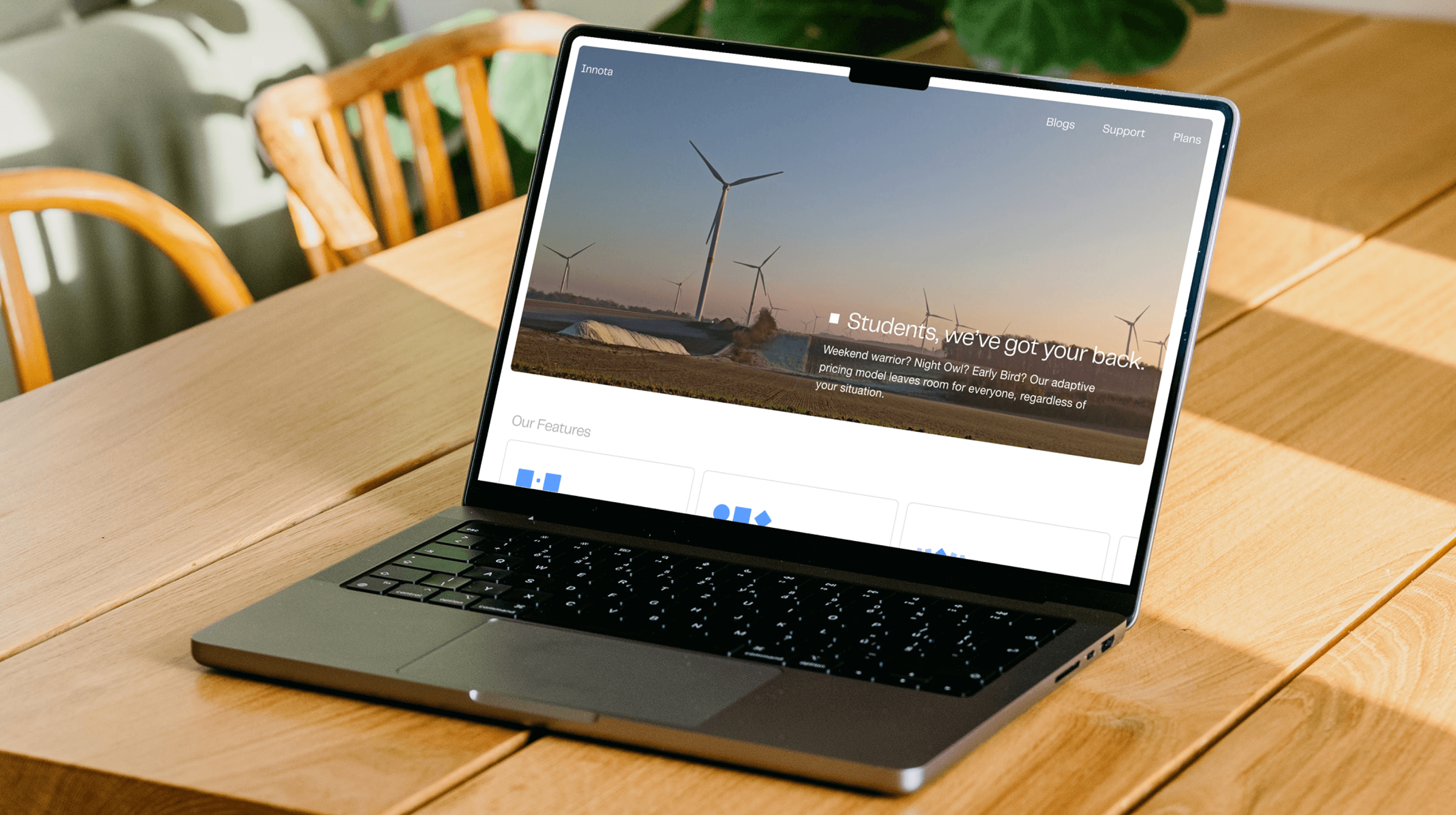 Laptop with Innota's home page open on a wooden desk